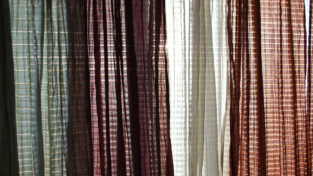 How to hang curtains on vertical blinds?