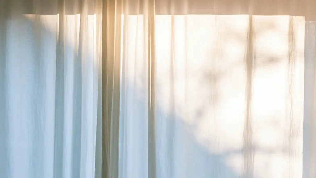 Do sheer curtains go in front or behind?